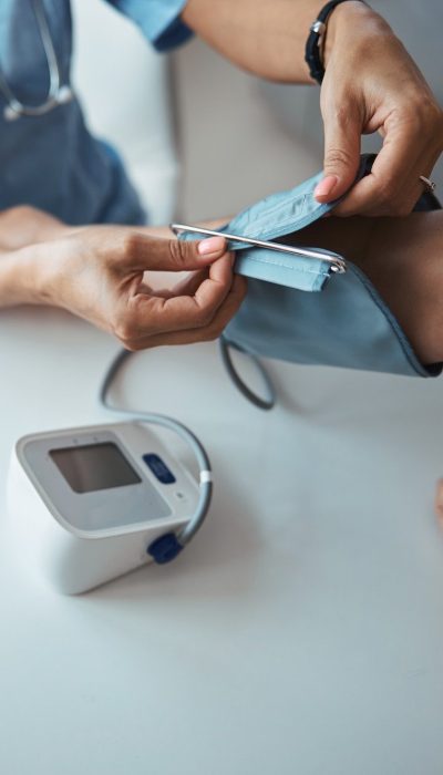 female-doctor-checking-patient-blood-pressure-in-clinic-e1682348846289